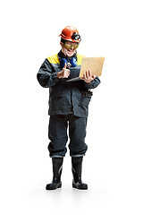 Image showing The studio shot of happy senior bearded male miner standing at the camera with laptop on a white background.