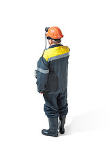 Image showing The studio shot of senior bearded male miner standing at the camera on a white background.