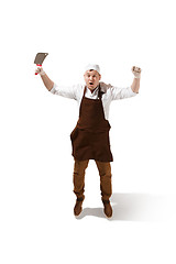 Image showing Smiling butcher jumping with a cleaver isolated on white background