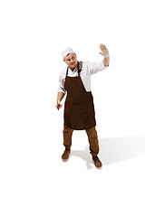 Image showing Angry aggressive butcher posing with a cleaver isolated on white background