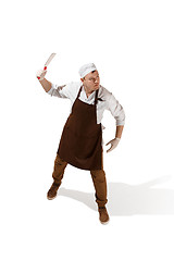 Image showing Angry aggressive butcher posing with a cleaver isolated on white background