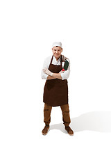 Image showing Smiling butcher posing with a cleaver isolated on white background