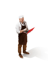 Image showing Serious butcher posing with a laptop isolated on white background