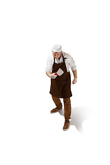 Image showing Angry aggressive butcher posing with a cleaver isolated on white background