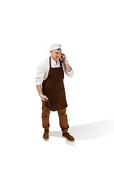 Image showing Smiling butcher posing with a cleaver isolated on white background