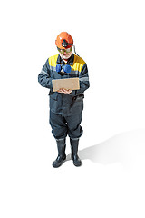 Image showing The studio shot of senior bearded male miner standing at the camera on a white background.