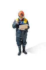 Image showing The studio shot of senior bearded male miner standing at the camera on a white background.