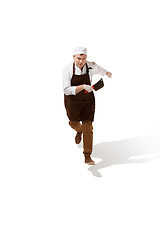 Image showing Serious butcher running with a cleaver isolated on white background