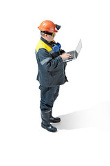 Image showing The studio shot of senior bearded male miner standing at the camera on a white background.