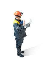 Image showing The studio shot of senior bearded male miner standing at the camera on a white background.