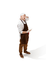 Image showing Smiling butcher posing with a cleaver isolated on white background