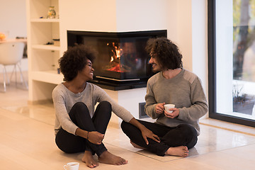 Image showing multiethnic couple  in front of fireplace