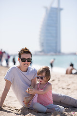 Image showing Mom and daughter on the beach