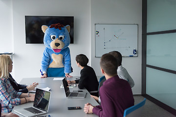 Image showing boss dresed as bear having fun with business people in trendy of