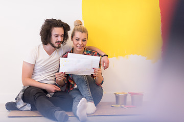 Image showing Happy young couple relaxing after painting