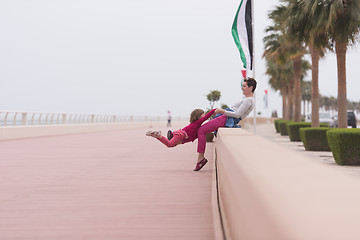 Image showing mother and cute little girl on the promenade by the sea