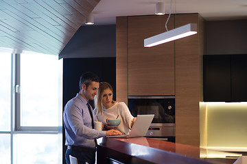 Image showing A young couple is preparing for a job and using a laptop