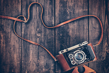 Image showing Old retro vintage camera on grunge wooden background