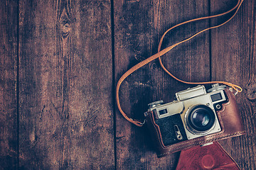 Image showing Old retro vintage camera on grunge wooden background