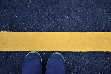 Image showing Standing on asphalt ground with yellow line