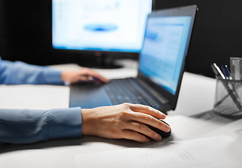 Image showing close up of female hand using computer mouse