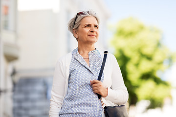 Image showing happy senior woman on city street in summer