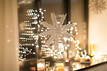 Image showing paper snowflake decoration hanging on window