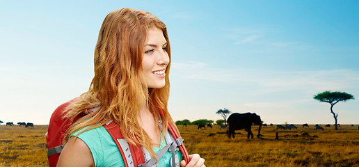 Image showing happy woman with backpack over african savannah