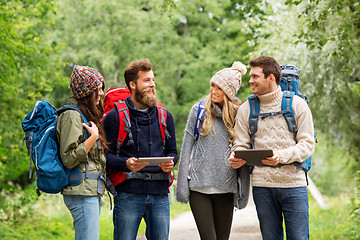 Image showing friends or travelers with backpacks and tablet pc