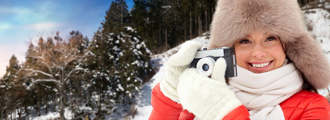 Image showing happy woman with film camera over winter forest