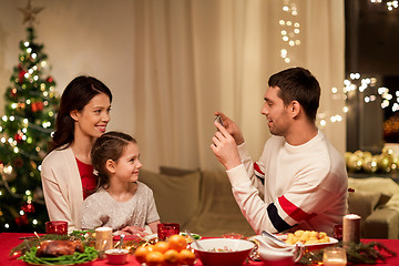 Image showing happy family taking picture at christmas dinner