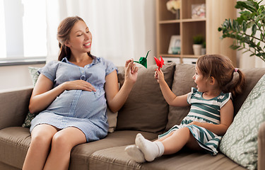 Image showing pregnant mother and daughter with crane origami