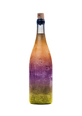 Image showing Old bottle of colorful liquid, covered in dust