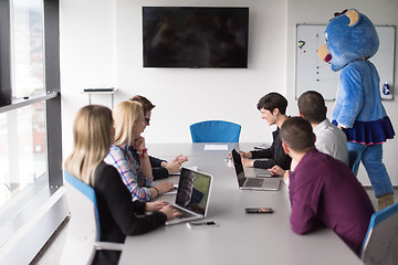 Image showing boss dresed as bear having fun with business people in trendy of