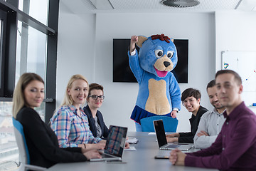 Image showing boss dresed as bear having fun with business people in trendy of