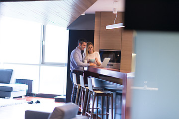 Image showing A young couple is preparing for a job and using a laptop