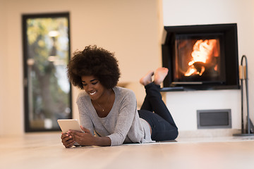 Image showing black women using tablet computer on the floor