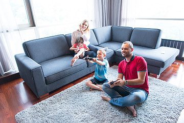 Image showing Happy family playing a video game