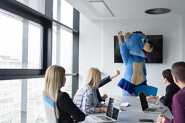 Image showing boss dresed as bear having fun with business people in trendy of