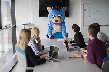 Image showing boss dresed as bear having fun with business people in trendy of