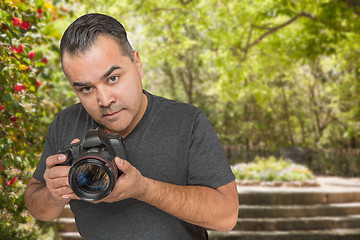 Image showing Hispanic Young Male Photographer With DSLR Camera Outdoors