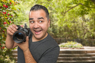 Image showing Hispanic Young Male Photographer With DSLR Camera Outdoors