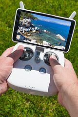 Image showing Hands Holding Drone Quadcopter Controller With Beautiful Lake Vi