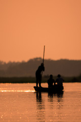 Image showing Blurred Men in a boat on a river silhouette