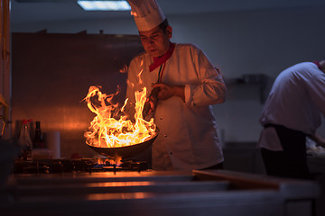 Image showing Chef doing flambe on food