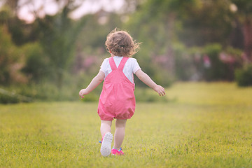 Image showing little girl spending time at backyard