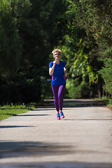 Image showing young female runner training for marathon