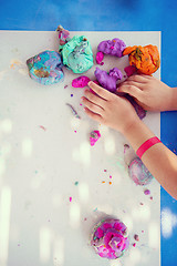 Image showing kid hands Playing with Colorful Clay