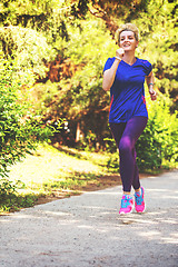 Image showing young female runner training for marathon