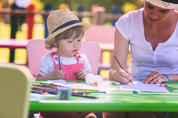 Image showing mom and little daughter drawing a colorful pictures